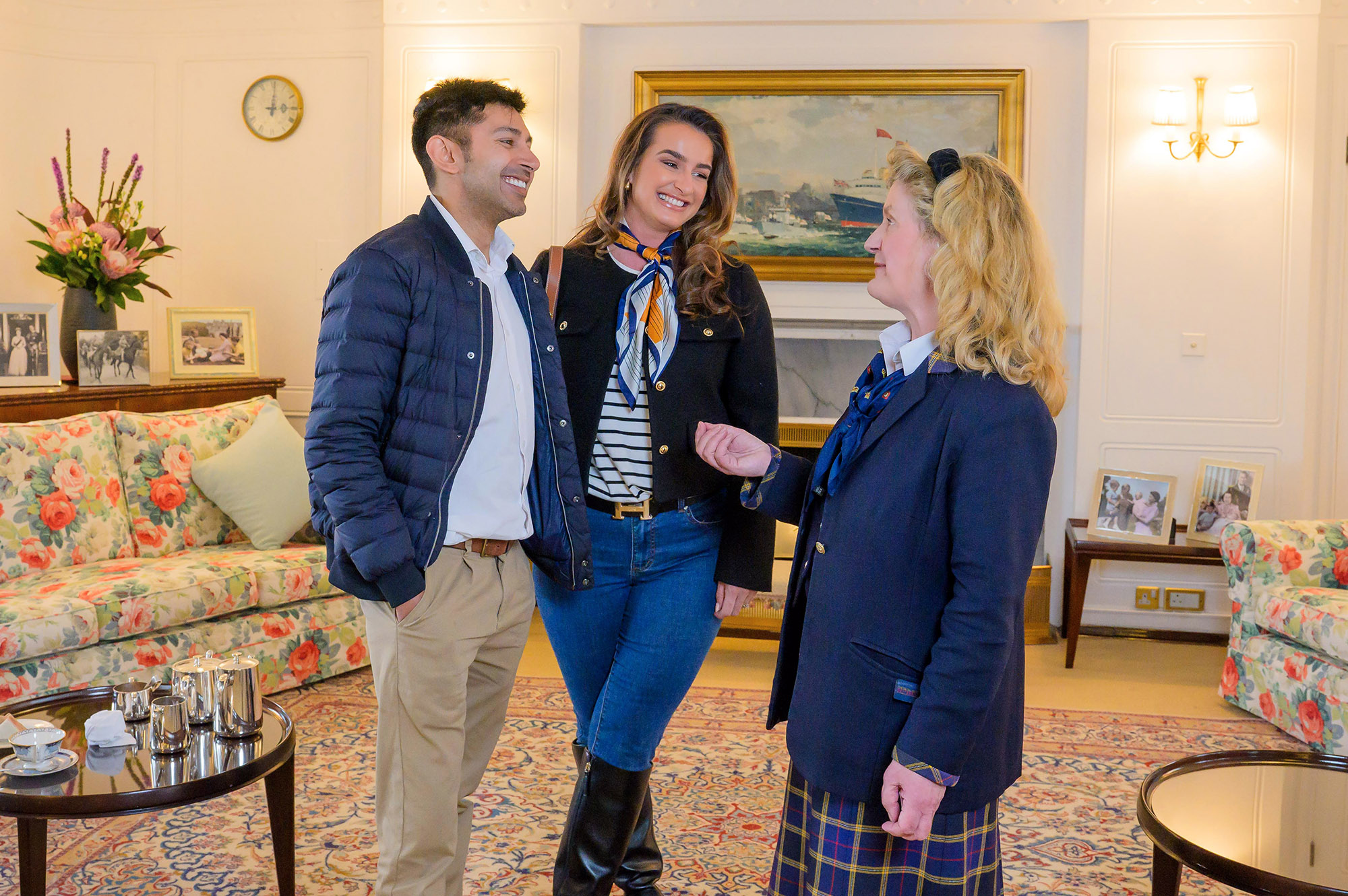 Our guide tells stories to a couple in the State Drawing Room, floral sofas are in the background.